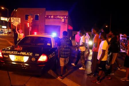 Protestors confront the police during disturbances following the police shooting of a man in Milwaukee, Wisconsin, U.S. August 14, 2016. REUTERS/Aaron P. Bernstein