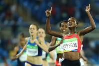 2016 Rio Olympics - Athletics - Final - Women's 1500m Final - Olympic Stadium - Rio de Janeiro, Brazil - 16/08/2016. Faith Chepngetich Kipyegon (KEN) of Kenya celebrates winning the gold. REUTERS/Lucy Nicholson