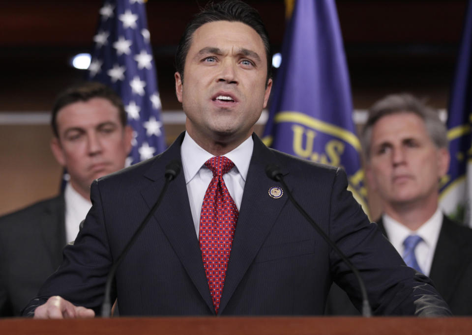 FILE - In this April 7, 2011, file photo, Rep. Michael Grimm, R-N.Y., center, accompanied by Rep. Duncan Hunter, R-Calif., left, House Majority Whip Kevin McCarthy of Calif., speaks during a news conference on Capitol Hill in Washington. Grimm’s attorney stated on Friday, April 25, 2014, that federal prosecutors in New York plan on filing criminal charges against the lawmaker. Lawyer William McGinley said Grimm is innocent and called the federal probe into the former FBI agent-turned-politician “a politically driven vendetta.” (AP Photo/Carolyn Kaster, File)