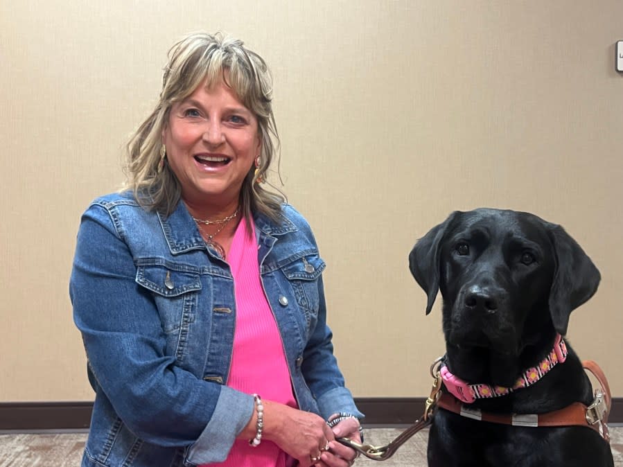 <em>DeAnna Moore with her guide dog, Whimsy (Photo: WJHL)</em>