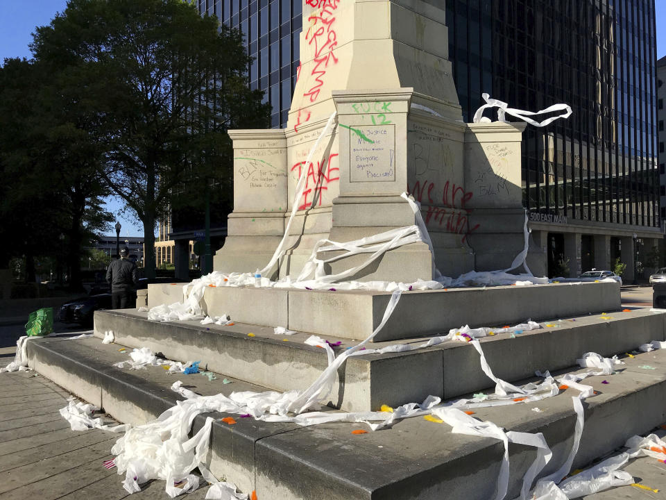 Graffiti, toilet papers and eggs are seen on and around the Confederate Monument in downtown Norfolk, Va., on Sunday, May 31, 2020. Protesters sprayed paint on the monument on Saturday night protest on May 30, 2020. (The N. Pham/The Virginian-Pilot via AP)