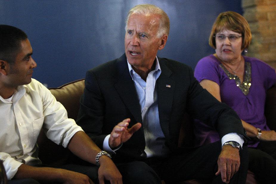 Vice President Joe Biden speaks with Luis de la Cruz of Schertz, of Texas, left, and Carolyn Gigerich, of Indianapolis, right, at a coffee shop Monday, August 13, 2012, following a rally in Durham, N.C. (AP Photo/The News & Observer, Travis Long) MANDATORY CREDIT