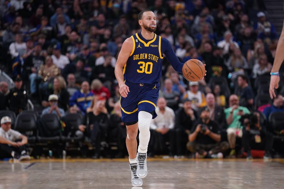 Golden State Warriors guard Stephen Curry dribbles the ball against the Dallas Mavericks during the third quarter  of Saturday's game.