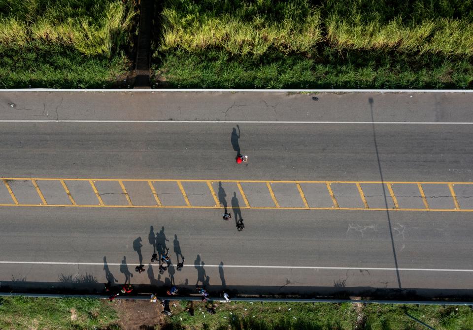 Migrants cross a highway just north of Ciudad Hidalgo in order to avoid a Mexican immigration checkpoint.