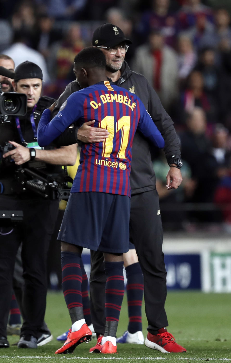 Liverpool coach Juergen Klopp and Barcelona's Ousmane Dembele embrace each other at the end of the Champions League semifinal, first leg, soccer match between FC Barcelona and Liverpool at the Camp Nou stadium in Barcelona Spain, Wednesday, May 1, 2019. (AP Photo/Joan Monfort)