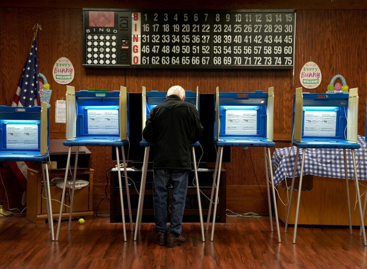 A voter casts his presidential primary vote at the Kennedy Manor polling place in Woonsocket on April 2.