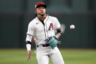 Arizona Diamondbacks' Ketel Marte fields a ground out hit by Chicago Cubs' Nico Hoerner during the fourth inning of a baseball game, Monday, April 15, 2024, in Phoenix. (AP Photo/Matt York)