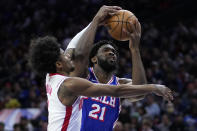 Philadelphia 76ers' Joel Embiid, right, tries to get a shot past Houston Rockets' Jalen Green during the first half of an NBA basketball game, Monday, Jan. 15, 2024, in Philadelphia. (AP Photo/Matt Slocum)