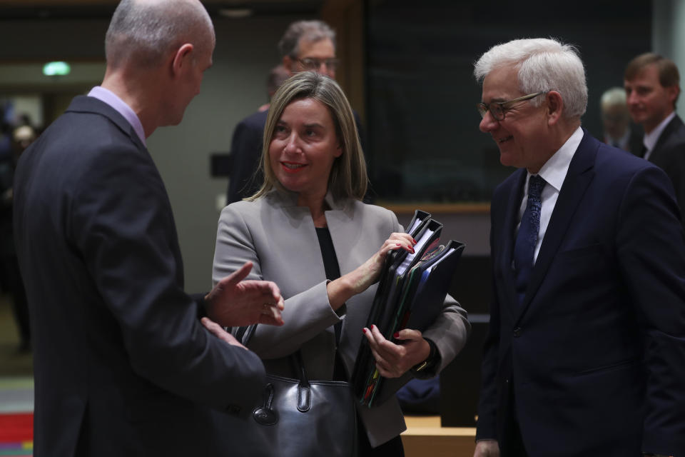 European Union Foreign Policy chief Federica Mogherini, centre, talks to The Netherlands' Foreign Minister Stef Blok, left, next to Poland's Foreign Minister Jacek Czaputowicz during an European Foreign Affairs Ministers meeting at the European Council headquarters in Brussels, Monday, Jan. 21, 2019. (AP Photo/Francisco Seco)