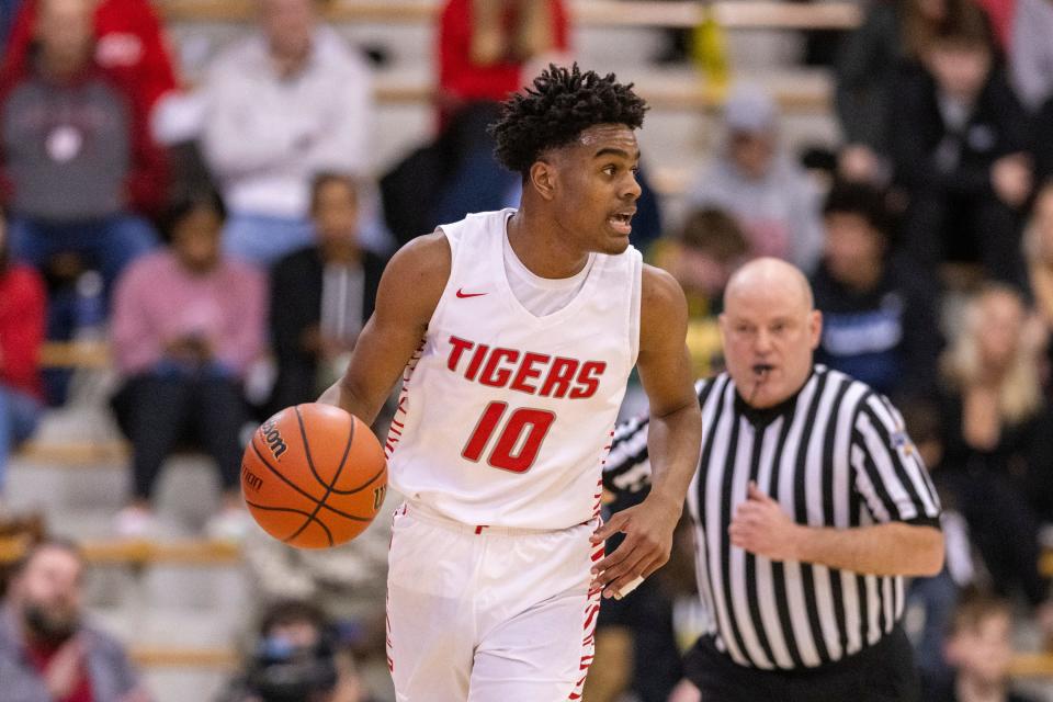 Fishers High School sophomore Jalen Haralson (10) brings the ball up court during the first half of an IHSAA Sectional basketball game against Zionsville High School, Friday, March 3, 2023, at Carmel High School.