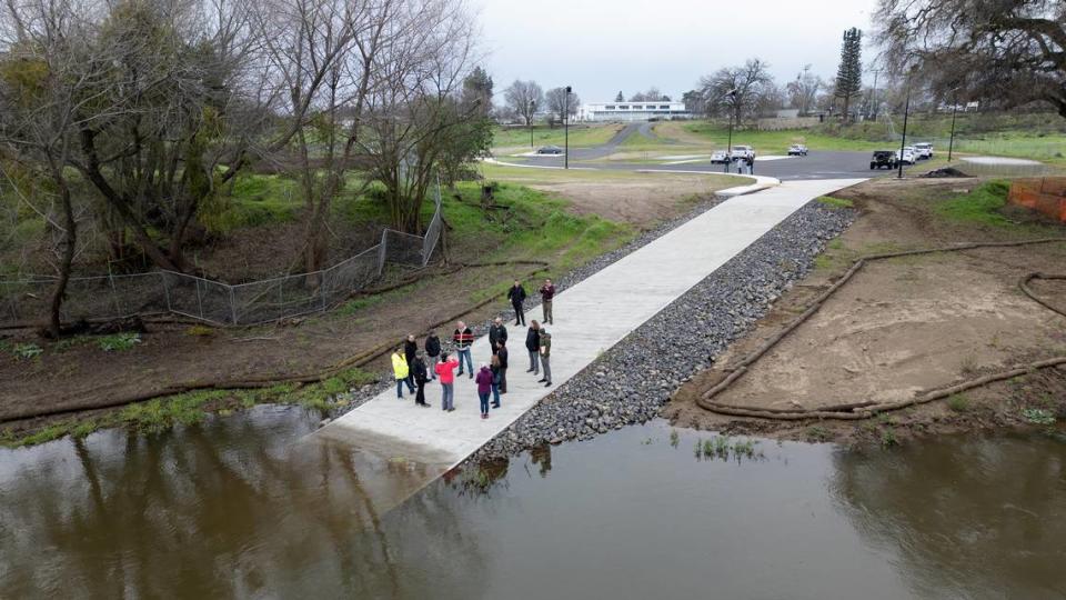 A group of local and state officials tours the new boat ramp at Tuolumne River Regional Park in Modesto, Calif., Wednesday, Feb. 7, 2024. The ramp received funding from the California Boating and Waterways Commission, which granted $780,000 for the project. The rest of the $1.79 million cost was covered by the park’s capital budget and fees on developers.