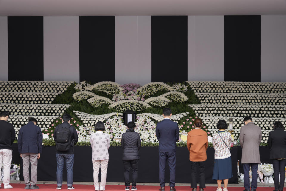 FILE - Mourners pay tribute for victims of a deadly accident following Saturday night's Halloween festivities at a joint memorial altar for victims at Seoul Plaza in Seoul, South Korea, Nov. 1, 2022. As bereaved families and friends struggle to make sense of a Halloween crowd crush that killed 156 people in South Korea’s capital, their grief is mixed with anger about officials’ failure to employ crowd controls in a small nightlife district jammed with tens of thousands of partiers. (AP Photo/Lee Jin-man, File)