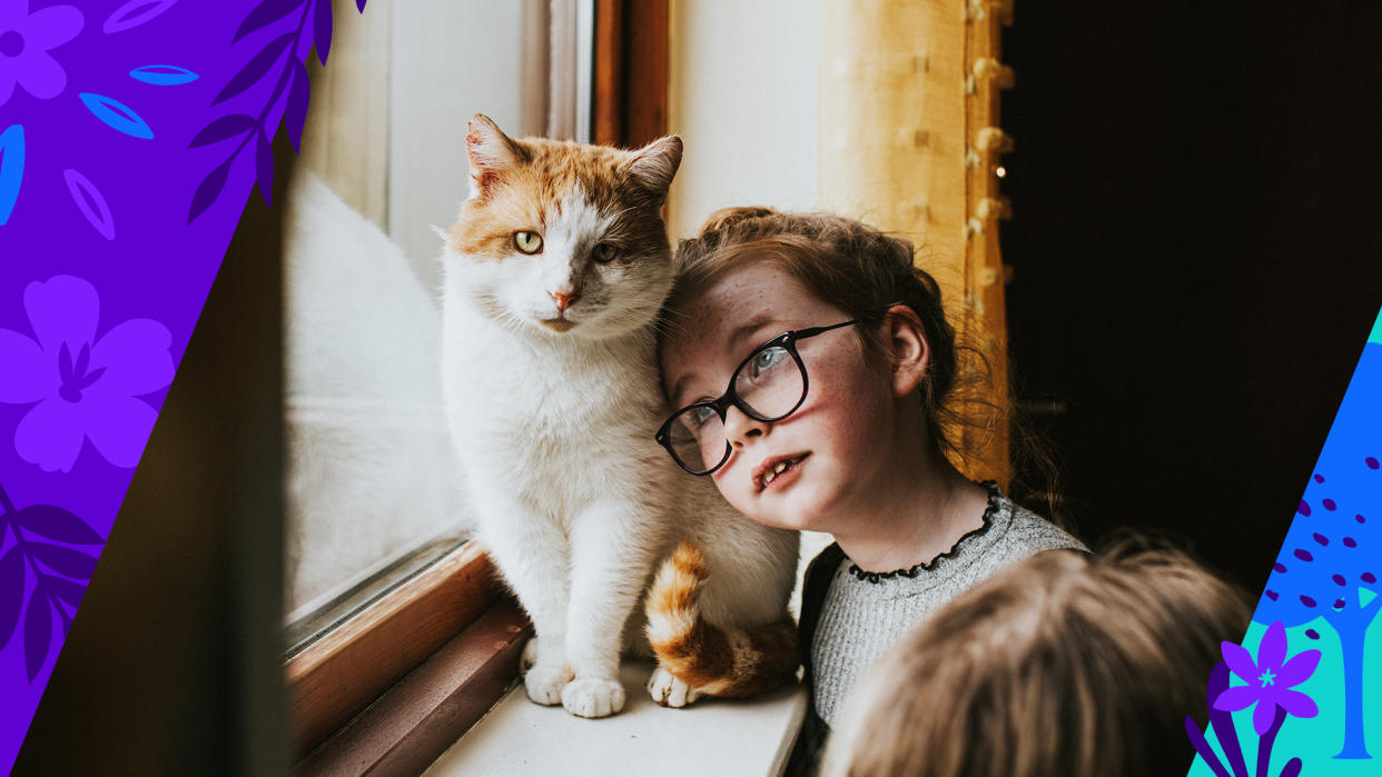 A young girl in glasses cozies up to a ginger cat.