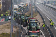 Tractors block the A4 highway near of Aranjuez, Spain, Tuesday, Feb. 6, 2024. From early morning, farmers across Spain have staged tractor protests across the country, blocking highways and causing traffic jams to demand of changes in European Union policies and funds and measures to combat production cost hikes. (AP Photo/Manu Fernandez)