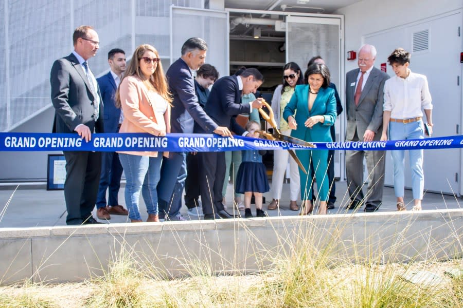 Public officials cut the ceremonial tape during the grand opening of Sun King Apartments in Sun Valley on March 25, 2024. (Los Angeles Unified School District)