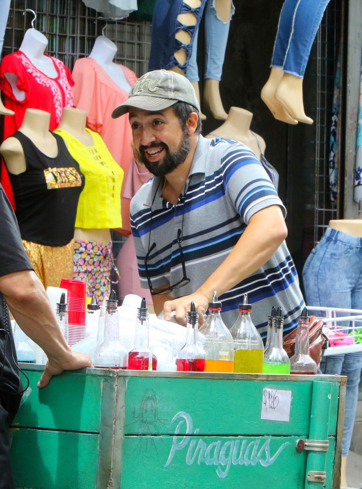 Lin-Manuel Miranda is sporting a new look for his role as the piragua (shaved ice) man in the upcoming film version of his Broadway hit “In the Heights”. The actor, donning a nearly full beard, was all smiles as he braved the rain on set in Washington Heights, Manhattan on June 26, 2019.