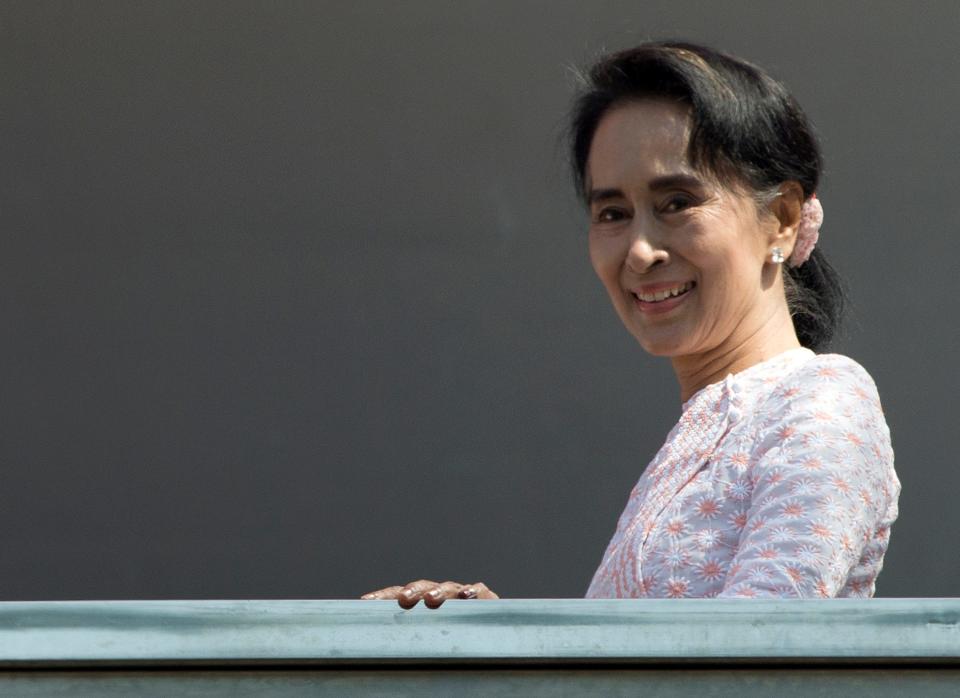 FILE - In this Nov. 9, 2015 file photo, leader of Myanmar's National League for Democracy party, Aung San Suu Kyi, smiles to her supporters after delivering a speech from a balcony of her party headquarters in Yangon, Myanmar. Myanmar's election panel has released results showing that Aung San Suu Kyi's opposition party has secured a historic majority in Myanmar's Parliament. With the tally still being counted, the Election Commission said Friday, Nov. 13 that Suu Kyi's National League for Democracy party has won 15 more seats, pushing it over the threshold it needed of 329 seats for a majority in the 664-member, two-house Parliament. (AP Photo/Mark Baker, File)