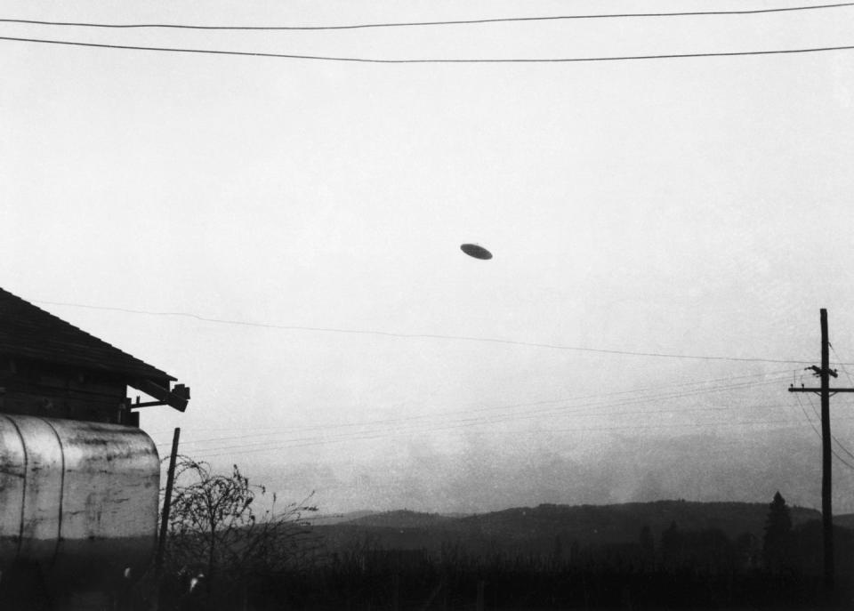 spooky urban legends   flying saucer flying over farm