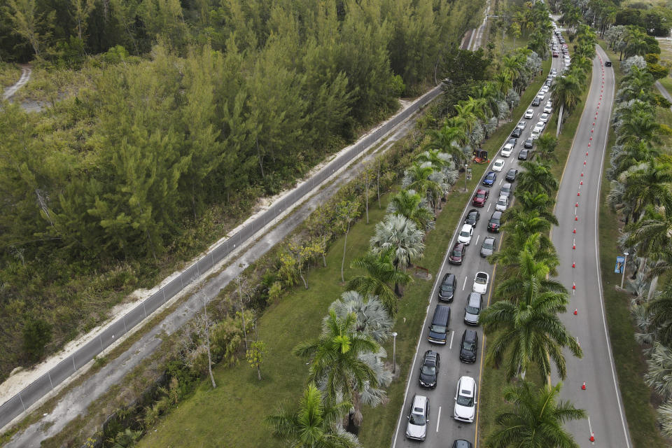 FILE - Cars wait in line at a drive-through COVID-19 testing site at Zoo Miami, Monday, Jan. 3, 2022, in Miami. The Biden administration is telling Congress that it needs an additional $30 billion to press ahead with the fight against COVID-19, officials said Tuesday, Feb. 15, 2022. (AP Photo/Rebecca Blackwell, File)