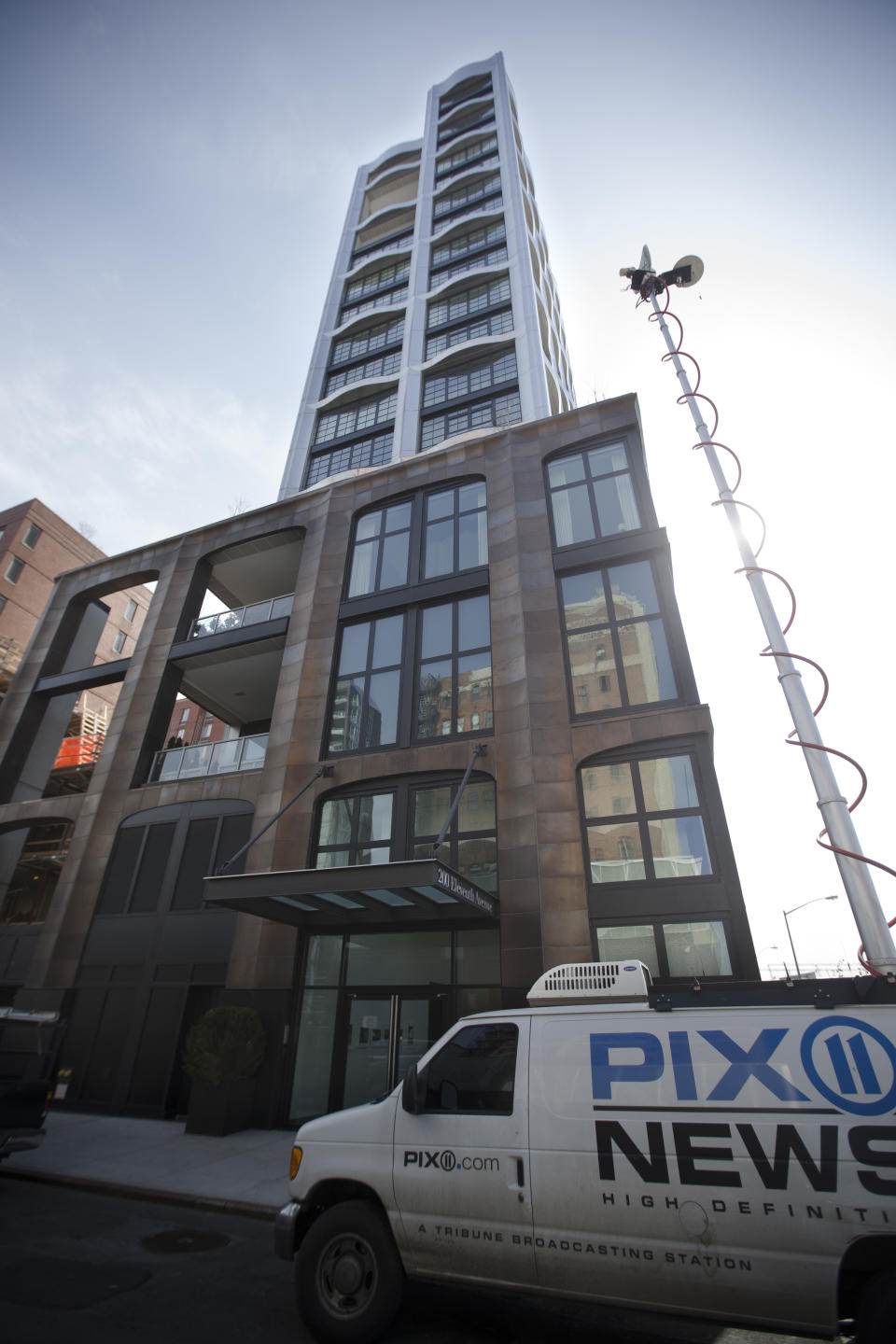 A news van is parked outside a building where the body of fashion designer L'Wren Scott was found, Monday, March 17, 2014, in New York. Scott, who was Mick Jagger's girlfriend, was found dead of a possible suicide, a law enforcement official said Monday. (AP Photo/John Minchillo)