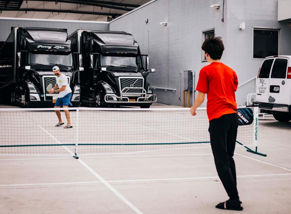 Country star Walker Hayes, left, plays pickleball with his son Chapel at Daily's Place Arena in Jacksonville, Fla., June 9, 2023