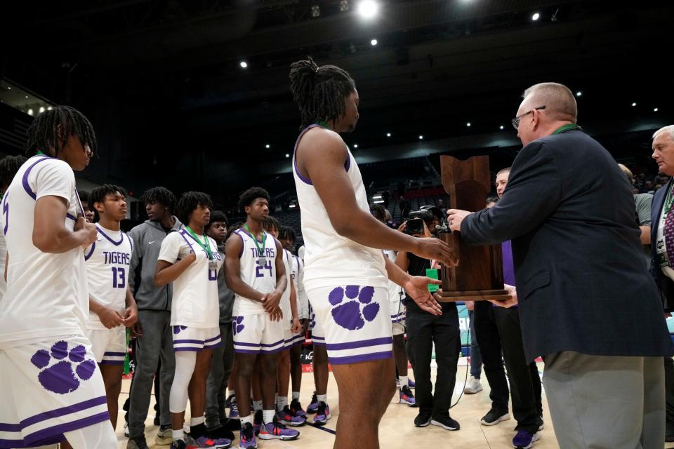 Pickerington Central's R.J. Keuchler accepts the Division I state runner-up trophy after a 53-47 loss to Akron Hoban on Sunday night.