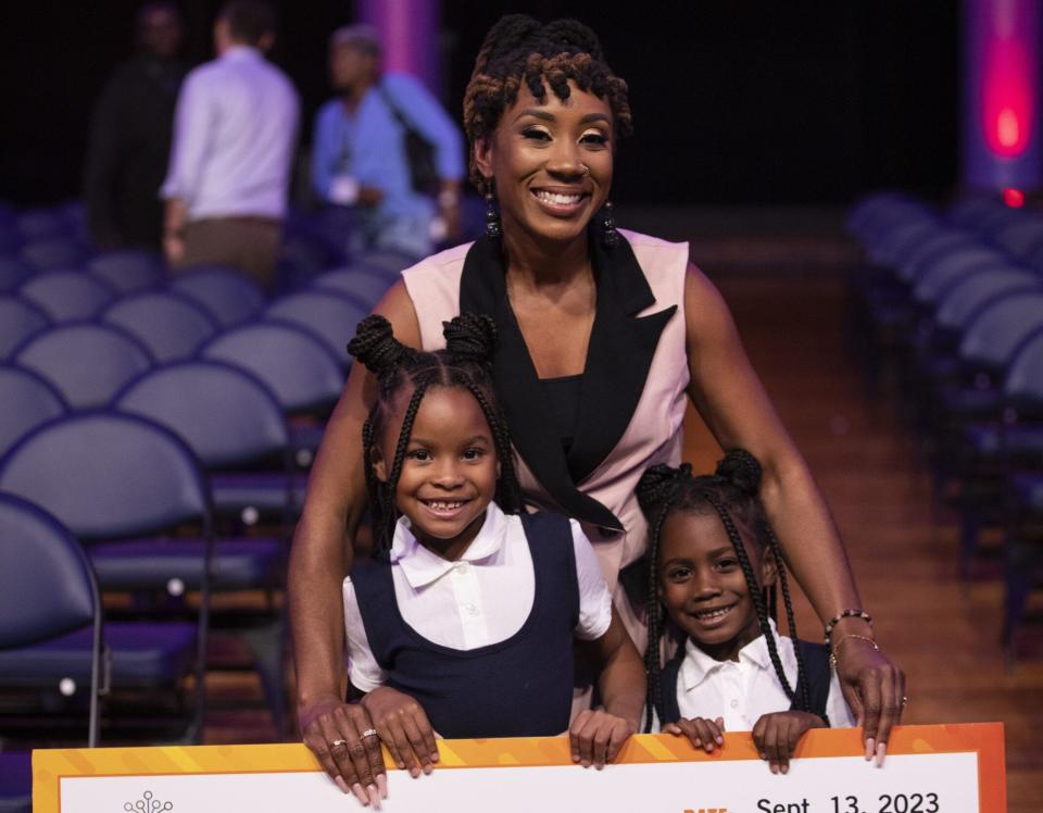 Rodriguez poses for a photo with her daughters after her Rev-Up MKE win.