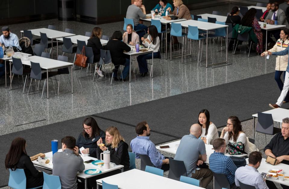 People eat their lunches as they sit near one of the food court areas during lunchtime inside the Renaissance Center in Detroit on Wednesday, Feb. 28, 2024.