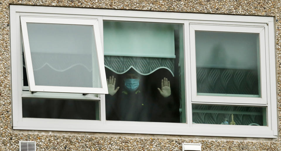 A person wearing a urgical mask inside of a building during lockdown in Melbourne 