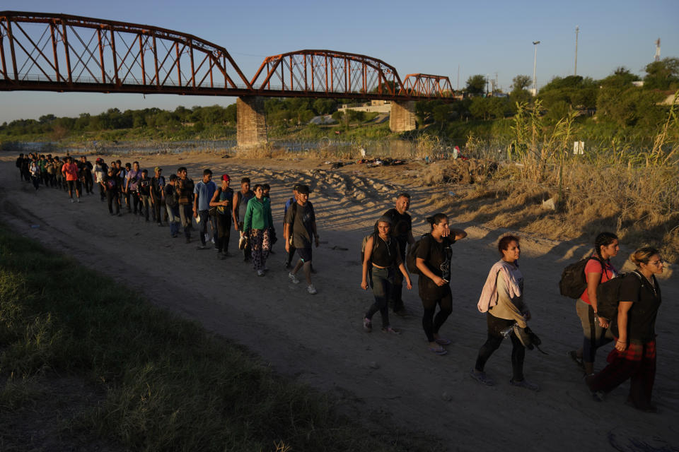 FILE - Migrants who crossed the Rio Grande and entered the U.S. from Mexico are lined up for processing by U.S. Customs and Border Protection, Sept. 23, 2023, in Eagle Pass, Texas. Most people in the U.S. see Mexico as an essential partner to stop drug trafficking and illegal border crossings, even as they express mixed views of Mexico's government, according to a new poll. (AP Photo/Eric Gay, File)