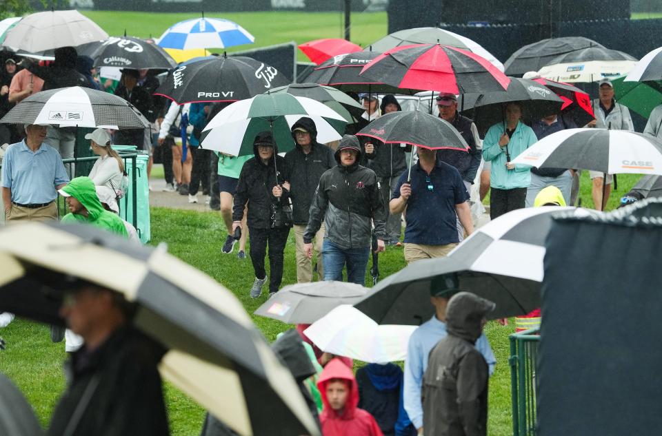 Golf fans pulled out their umbrellas and walked off the course during a weather delay at the Valhalla Golf Course in Louisville, Ky. on May. 14, 2024.