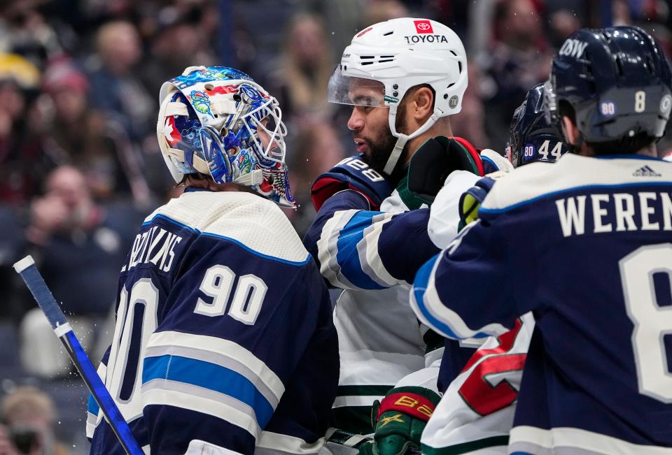 Columbus Blue Jackets goaltender Elvis Merzlikins (90) gets in the face of Minnesota Wild left wing Jordan Greenway (18) during the second period of the NHL hockey game at Nationwide Arena in Columbus on March 11, 2022.