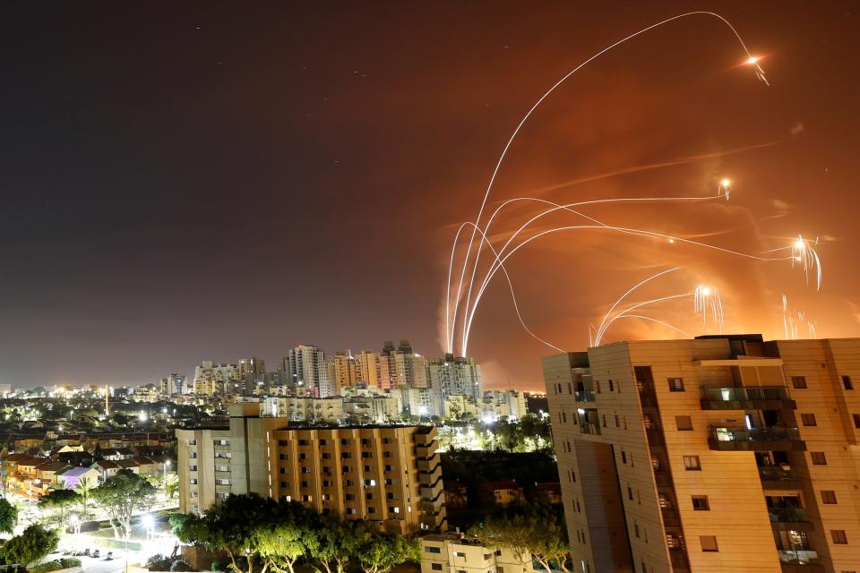 <p>Streaks of light are seen as Israel's Iron Dome anti-missile system intercept rockets launched from the Gaza Strip</p> (REUTERS)