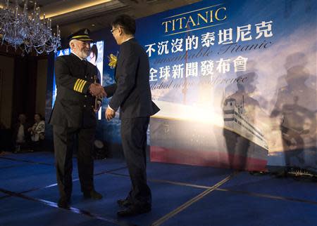 Bernard Hill (L), actor of captain Edward Smith in the 1997 Titanic movie, shakes hands with Su Shaojun, CEO of Seven-Star Energy Investment Group (SSEG), during a news conference in Hong Kong January 12, 2014. REUTERS/Tyrone Siu