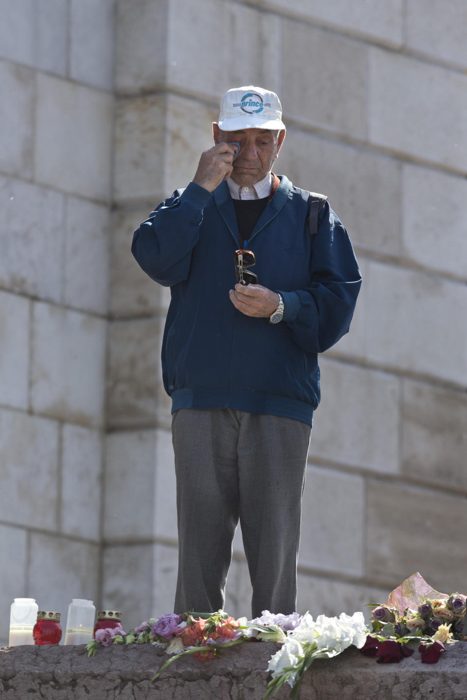 A man wipes tears off as he stands on the banks of the Danube river where a sightseeing boat had capsized in Budapest, Hungary, Saturday, June 1, 2019. As the rescue operation continued on the Danube on Saturday, Hungarian authorities predicted it would take an extended search to find the 21 people still missing after a boat carrying South Korean tourists was rammed by a cruise ship and sank into the river in Budapest. (AP Photo/Marko Drobnjakovic)