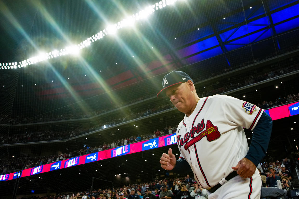 ATLANTA, GA - OCTOBER 16: Brian Snitker #43 of the Atlanta Braves runs out to the field prior to during Game 1 of the NLCS between the Los Angeles Dodgers and the Atlanta Braves at Truist Park on Saturday, October 16, 2021 in Atlanta, Georgia. (Photo by Daniel Shirey/MLB Photos via Getty Images)