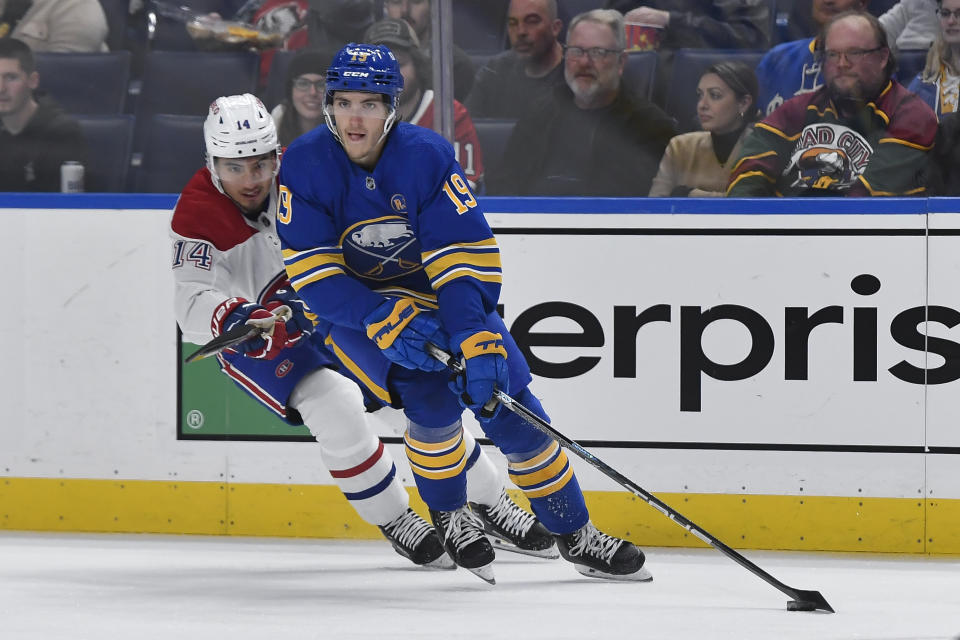 Buffalo Sabres center Peyton Krebs, right, skates the puck away from Montreal Canadiens center Nick Suzuki during the first period of an NHL hockey game in Buffalo, N.Y., Monday, Oct. 23, 2023. (AP Photo/Adrian Kraus)