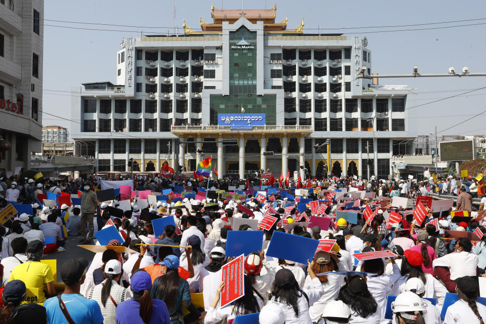 Anti-coup protesters hold a rally in front of the Mandalay railway station in Mandalay, Myanmar on Monday, Feb. 15, 2021. Myanmar's military leaders extended their detention of Aung San Suu Kyi, whose remand was set to expire on Monday, as protests continued to roil the Southeast Asian country following a military coup earlier this month. (AP Photo)