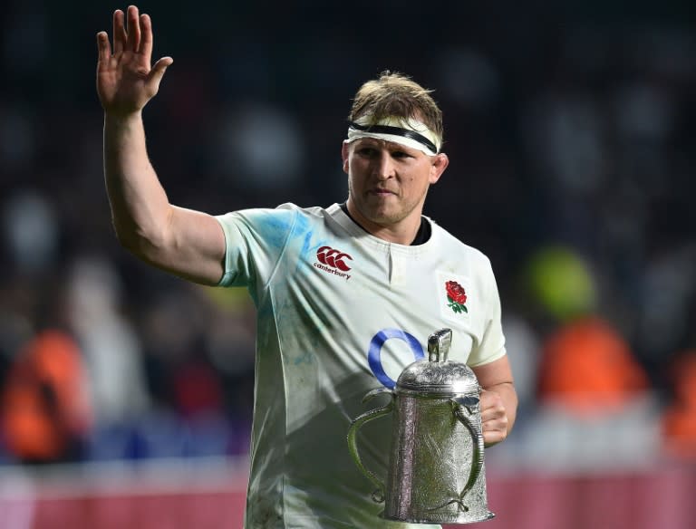 England's Dylan Hartley holds the Calcutta Cup trophy as leaves the pitch atfter winning the Six Nations international rugby union match against Scotland at Twickenham stadium in south west London on March 11, 2017