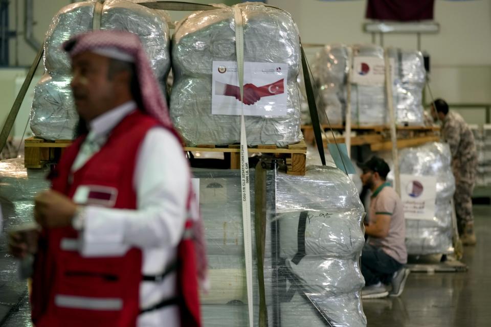 Qatari Red Crescent employees prepare assistance packages to be sent for earthquake hit areas of Turkey, at Al-Udeid Air Base in Doha, Qatar, Tuesday, Feb. 7, 2023. (AP Photo/Kamran Jebreili)