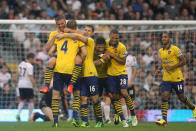 Arsenal's Lukas Podolski celebrates his first goal during the Barclays Premier League match at Craven Cottage, London.