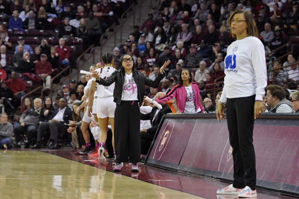 South Carolina head coach Dawn Staley, back center, and LSU head coach Nikki Fargas, front right, react during the first half of an NCAA college basketball game Thursday, Feb. 20, 2020, in Columbia, S.C. (AP Photo/Richard Shiro)
