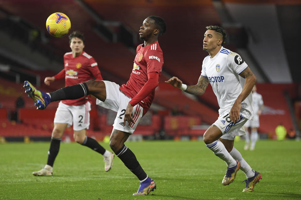 Manchester United's Victor Lindelof controls the ball in front of Leeds United's Raphinha during an English Premier League soccer match between Manchester United and Leeds United at the Old Trafford stadium in Manchester, England, Sunday Dec. 20, 2020. (Michael Regan/Pool via AP)