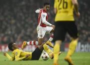 Borussia Dortmund's Pierre-Emerick Aubameyang challenges Arsenal's Alexis Sanchez (C) during their Champions League group D soccer match in London November 26, 2014. REUTERS/Dylan Martinez