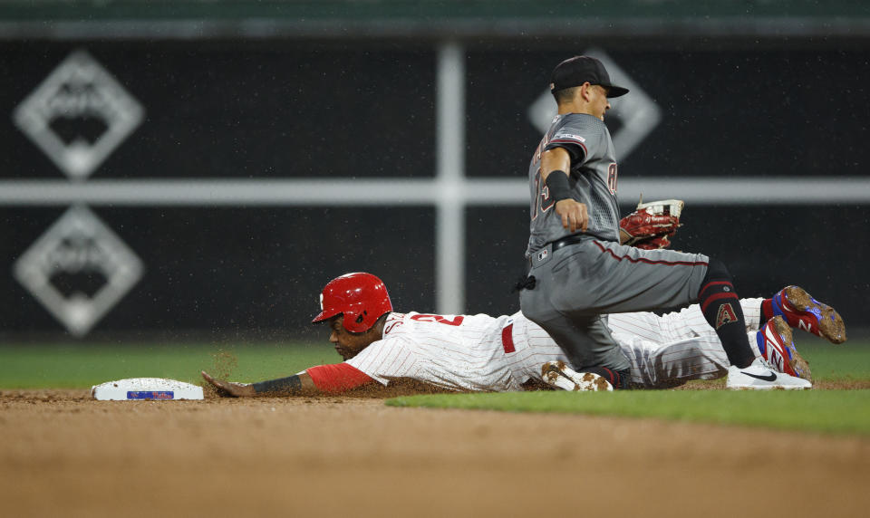 Philadelphia Phillies' Jean Segura, left, steals second base past Arizona Diamondbacks second baseman Ildemaro Vargas during the third inning of a baseball game, Monday, June 10, 2019, in Philadelphia. (AP Photo/Matt Slocum)