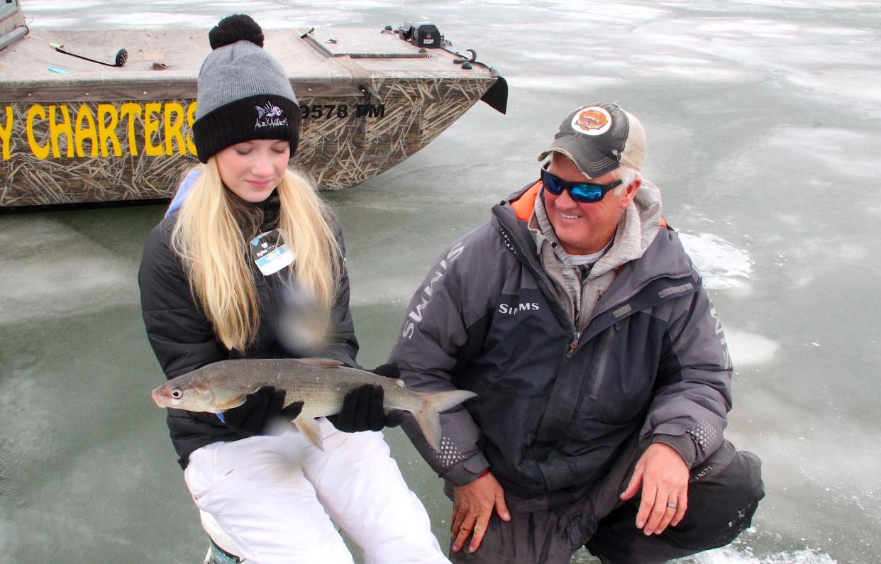 Portia Alexander holds a lake whitefish caught on a Jan. 28 fishing outing with her father, Bret Alexander, on the ice of Green Bay.