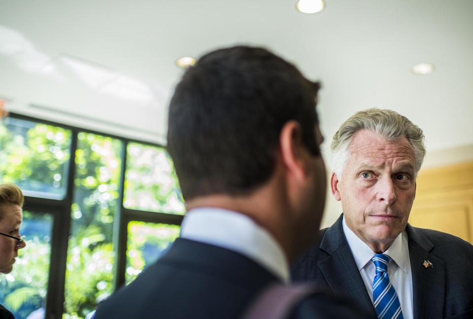 Virginia Gov. Terry McAuliffe huddles with staff before delivering a speech during the 2017 Center for American Progress Ideas Conference. (Photo: Melina Mara/The Washington Post via Getty Images)