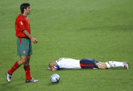 FILE - In this June 24, 2004 file photo Portugal's Luis Figo, left, stands over England's David Beckham during the Euro 2004 quarter final soccer match between England and Portugal at the Luz Stadium in Lisbon, Portugal. (AP Photo/Armando Franca, File)