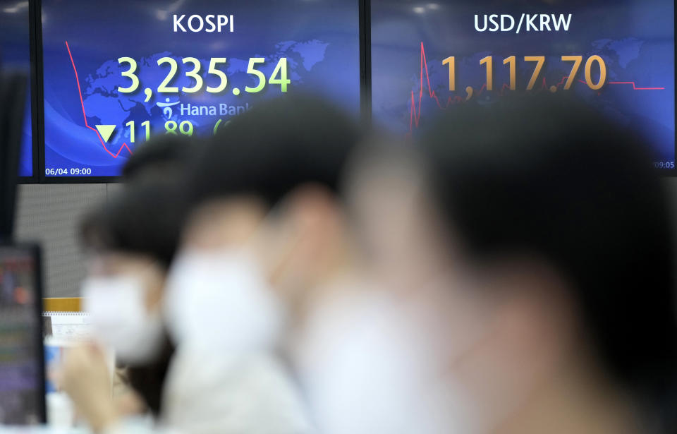 Currency traders watch computer monitors near the screens showing the Korea Composite Stock Price Index (KOSPI), left, and the foreign exchange rate between U.S. dollar and South Korean won at the foreign exchange dealing room in Seoul, South Korea, Friday, June 4, 2021. Asian shares mostly slipped Friday, dragged lower by a decline in technology stocks on Wall Street. (AP Photo/Lee Jin-man)