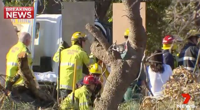 Boards are being used to buttress the trench. Source: 7 News